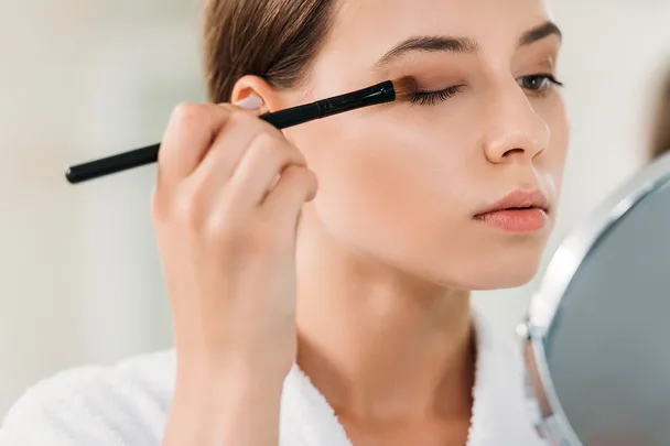 woman applying eyeshadow