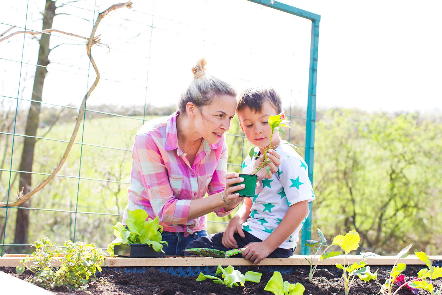 woman teaching child about gardening