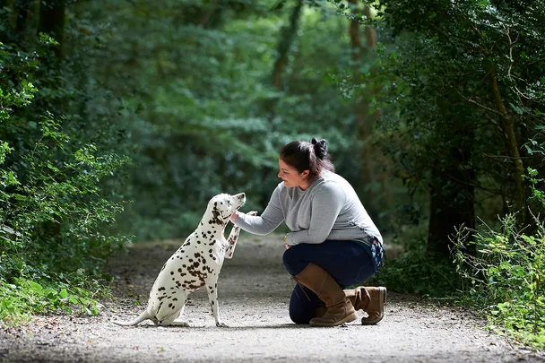 woman kneeling with dog