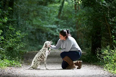 woman kneeling with dog