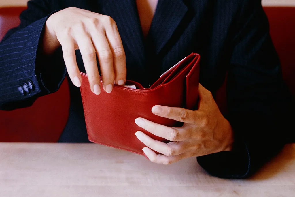 woman holding red wallet