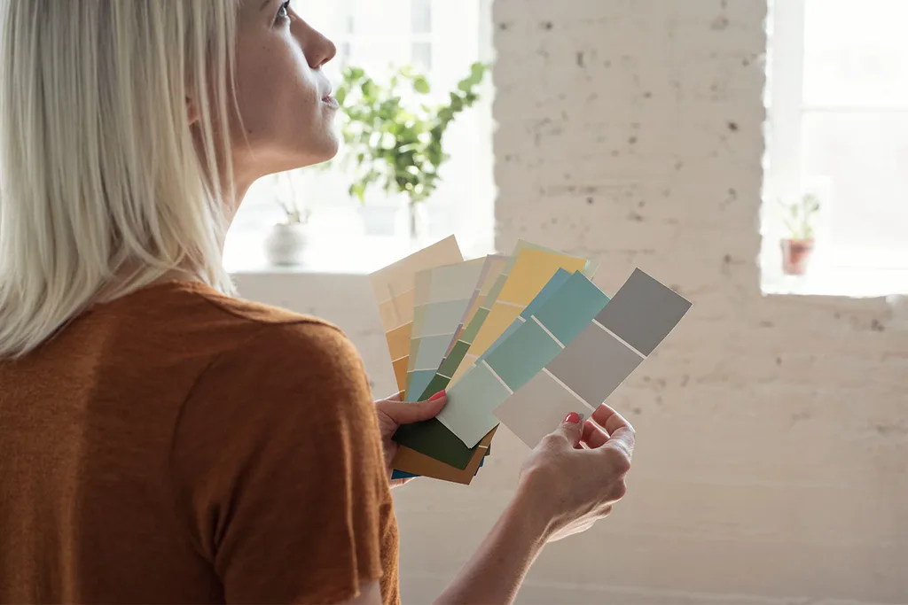 Woman choosing paint colour