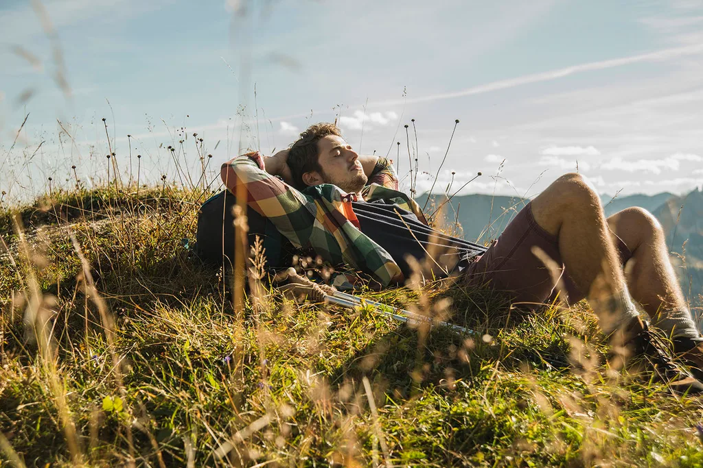 man sleeping outside on grass