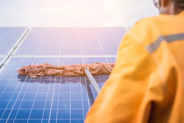 man cleaning solar panels