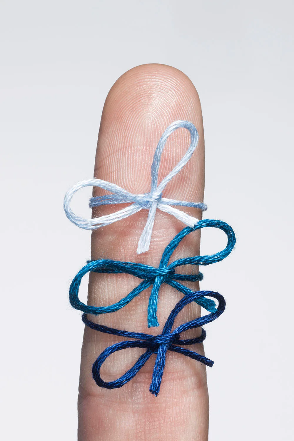 reminders ribbon tied to finger