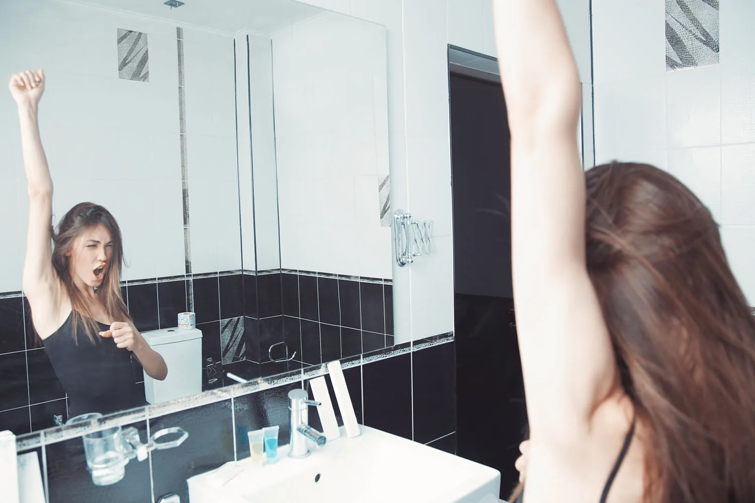 woman singing into mirror