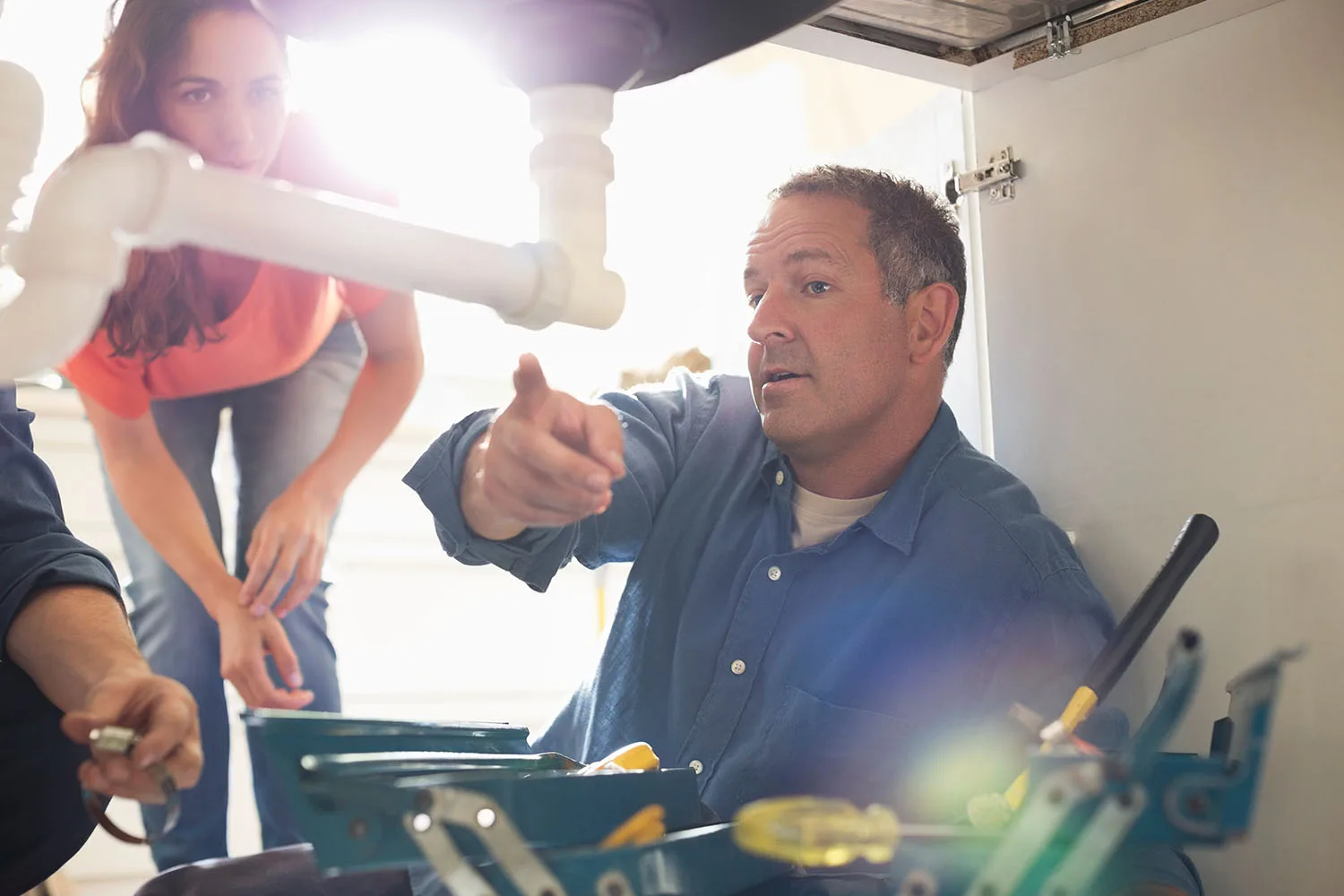 man under sink plumber