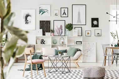 living room with a wall full of art prints
