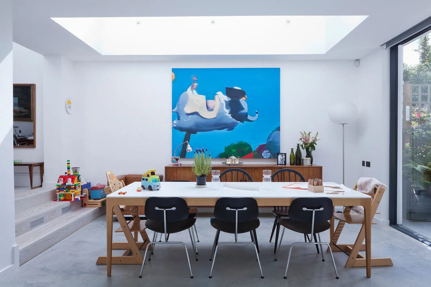 blue painting hanging on wall in dining room