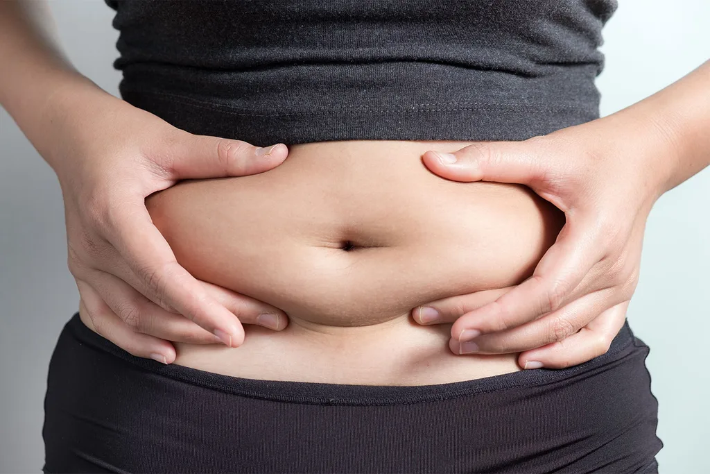 Woman squeezing tummy with hands