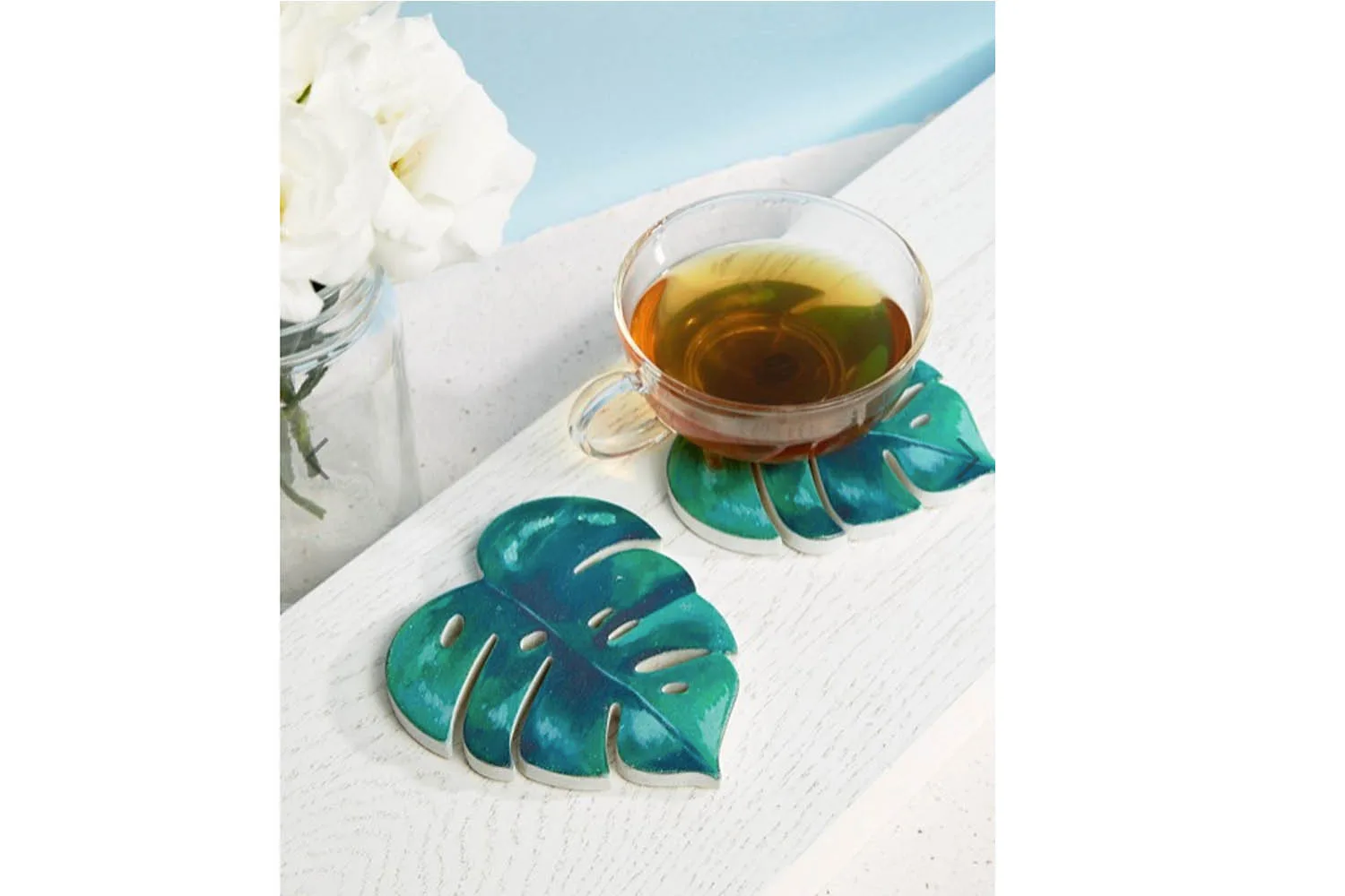 leaf coaster and cup of tea