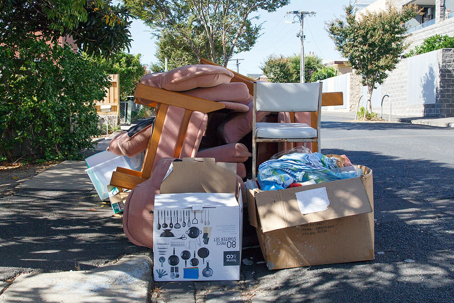 pile of old furniture on street