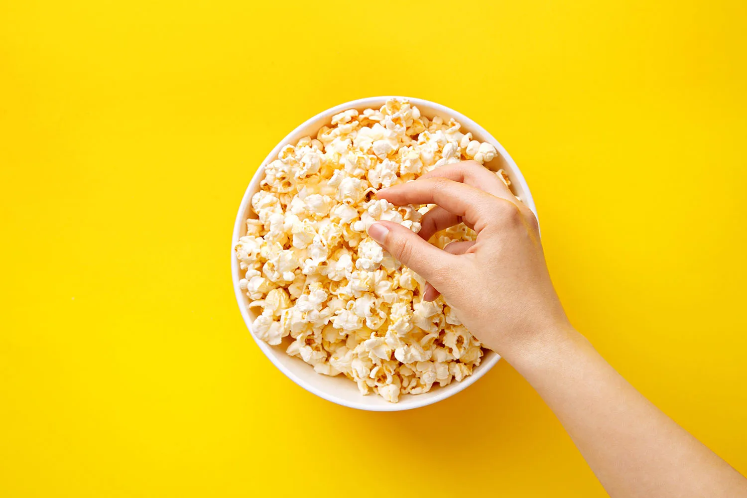 bowl of popcorn on yellow background