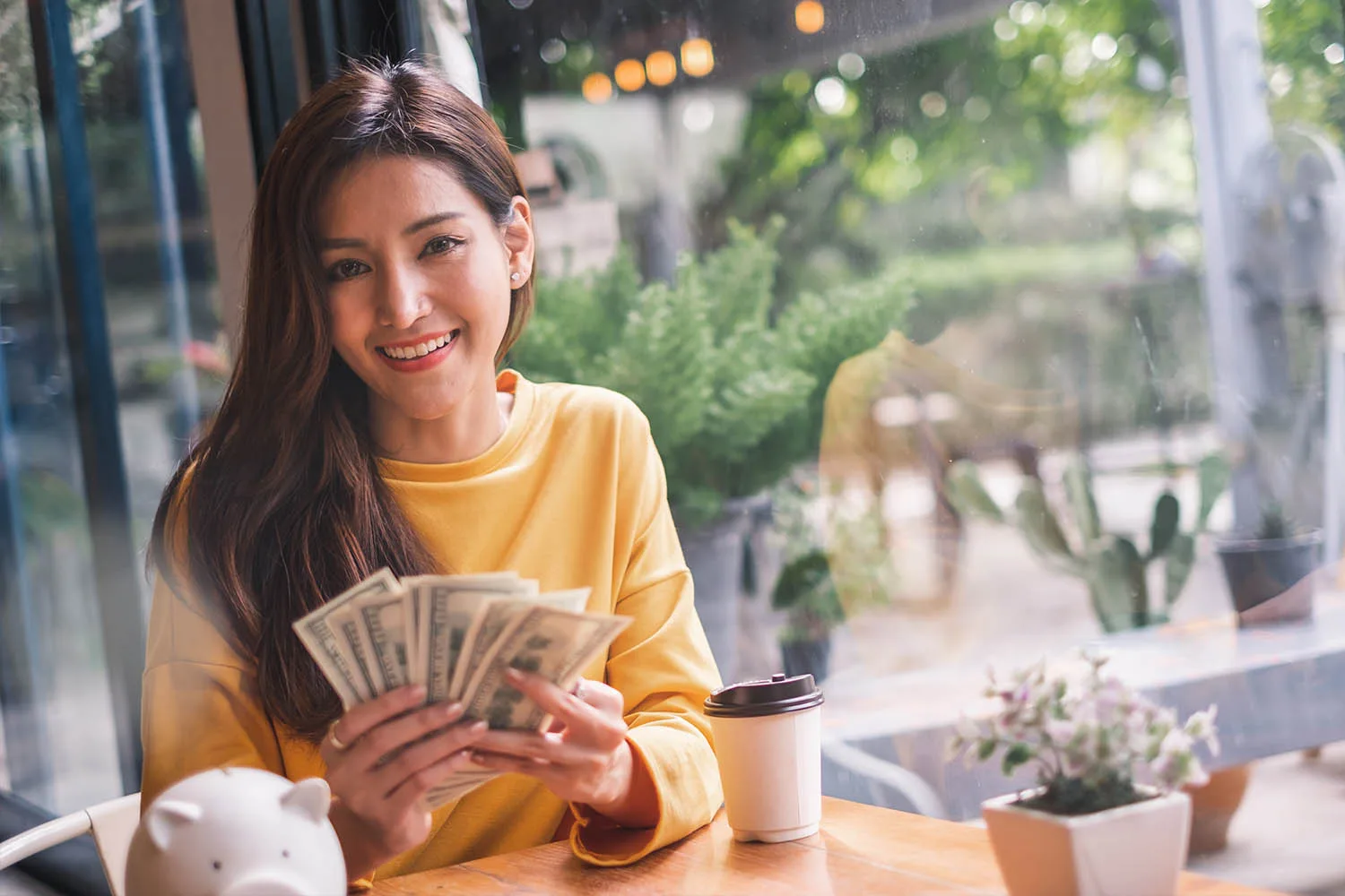 woman holding american bank notes