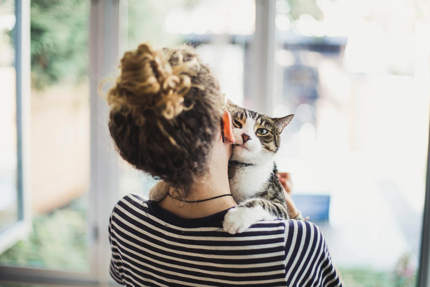 woman holding cat