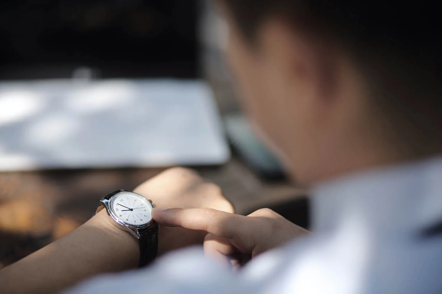 man looking at watch