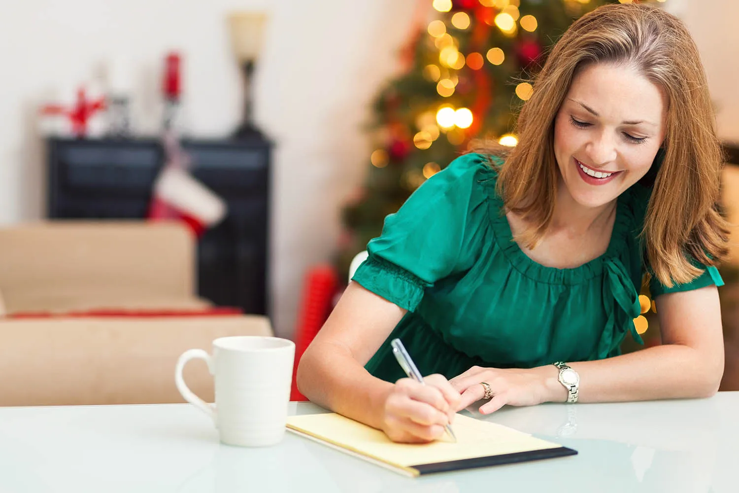 woman writing on notepad