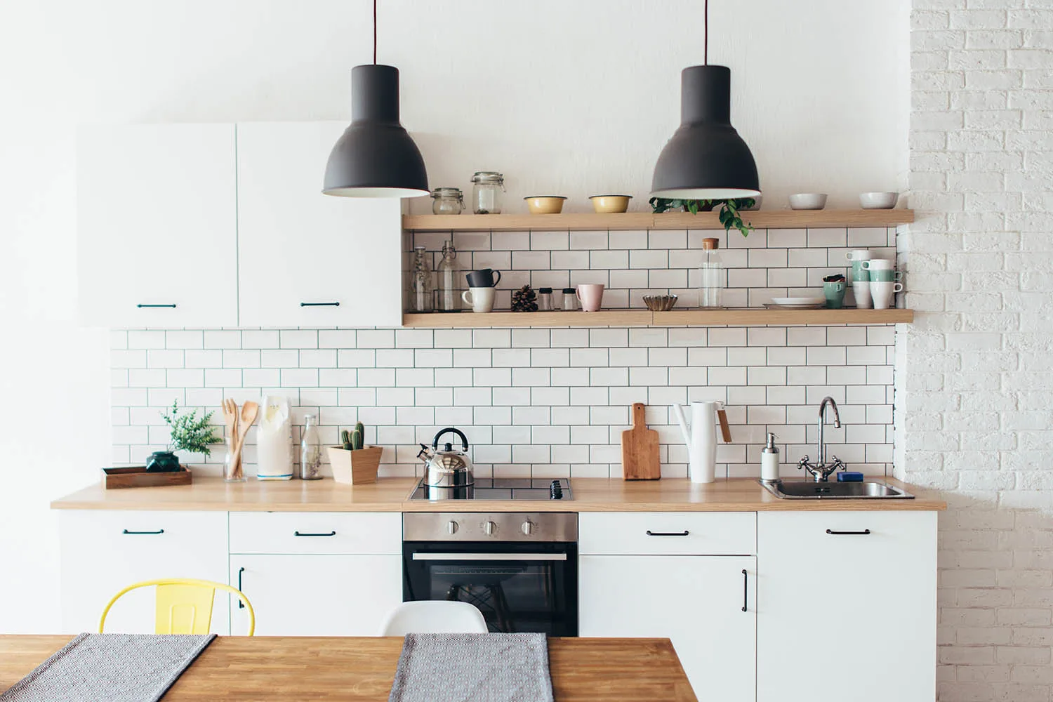 small white kitchen with subway tiles and blonde timber