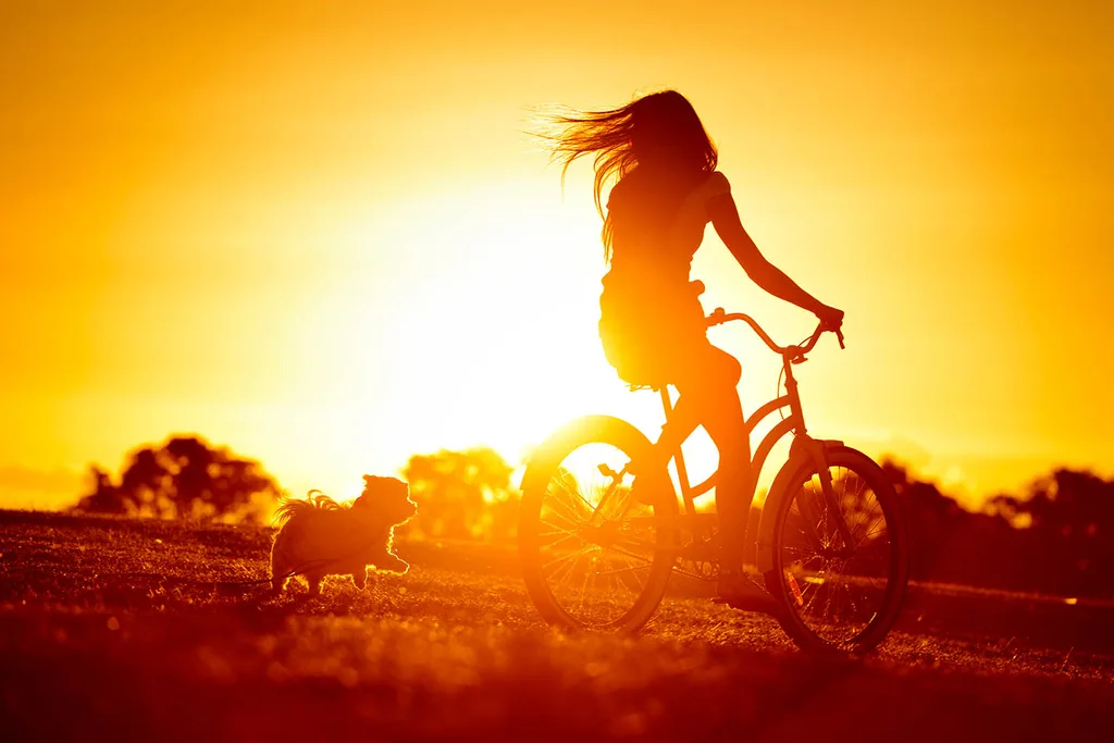 girl riding bike at dusk