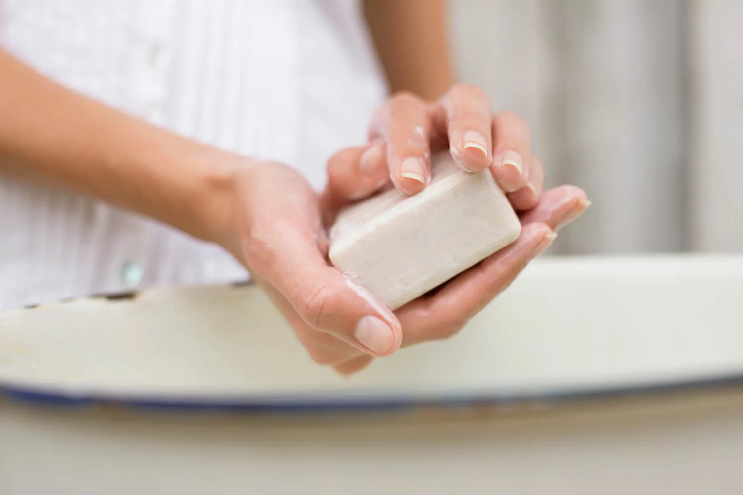 hands being washed with a bar of soap