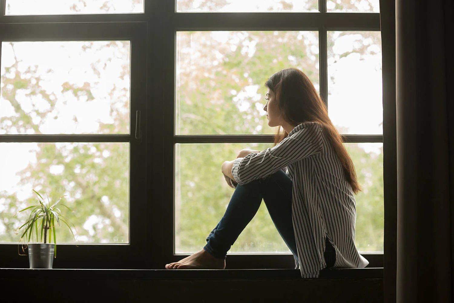 woman sitting in window