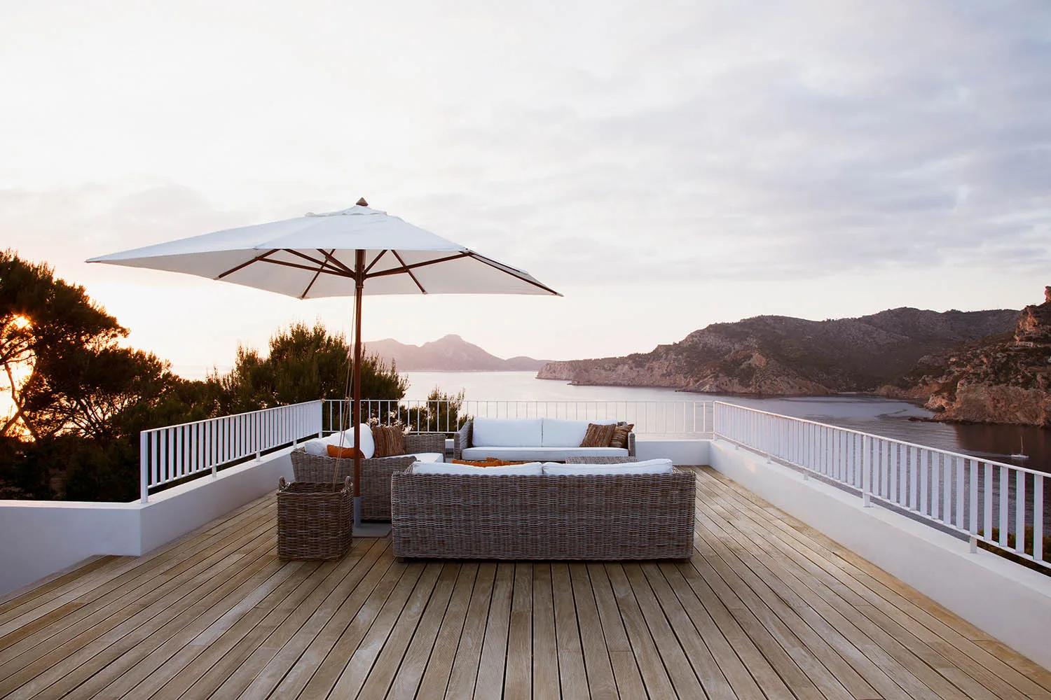 balcony style deck idea with white fence and umbrella