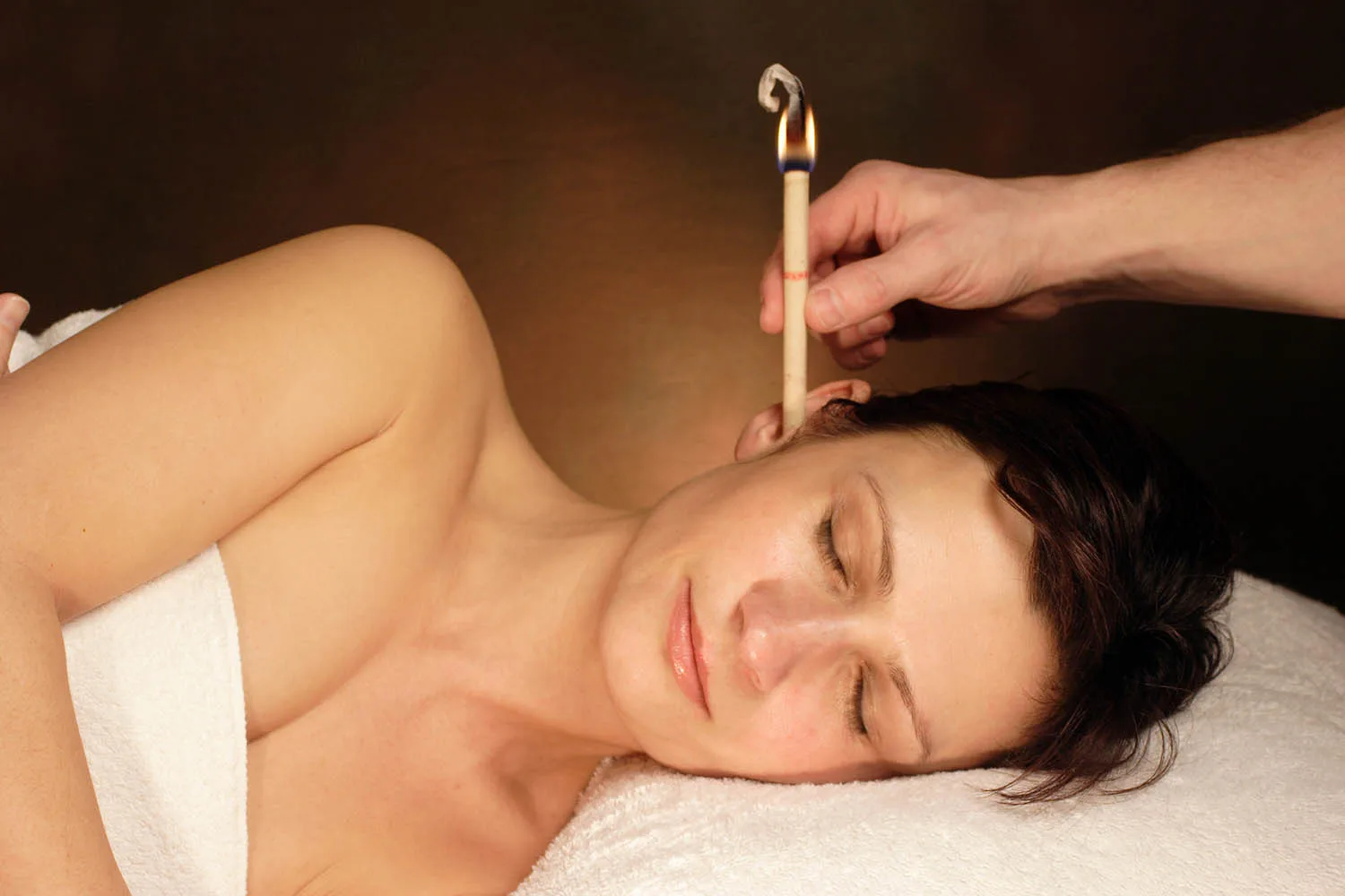 woman participating in ear candling