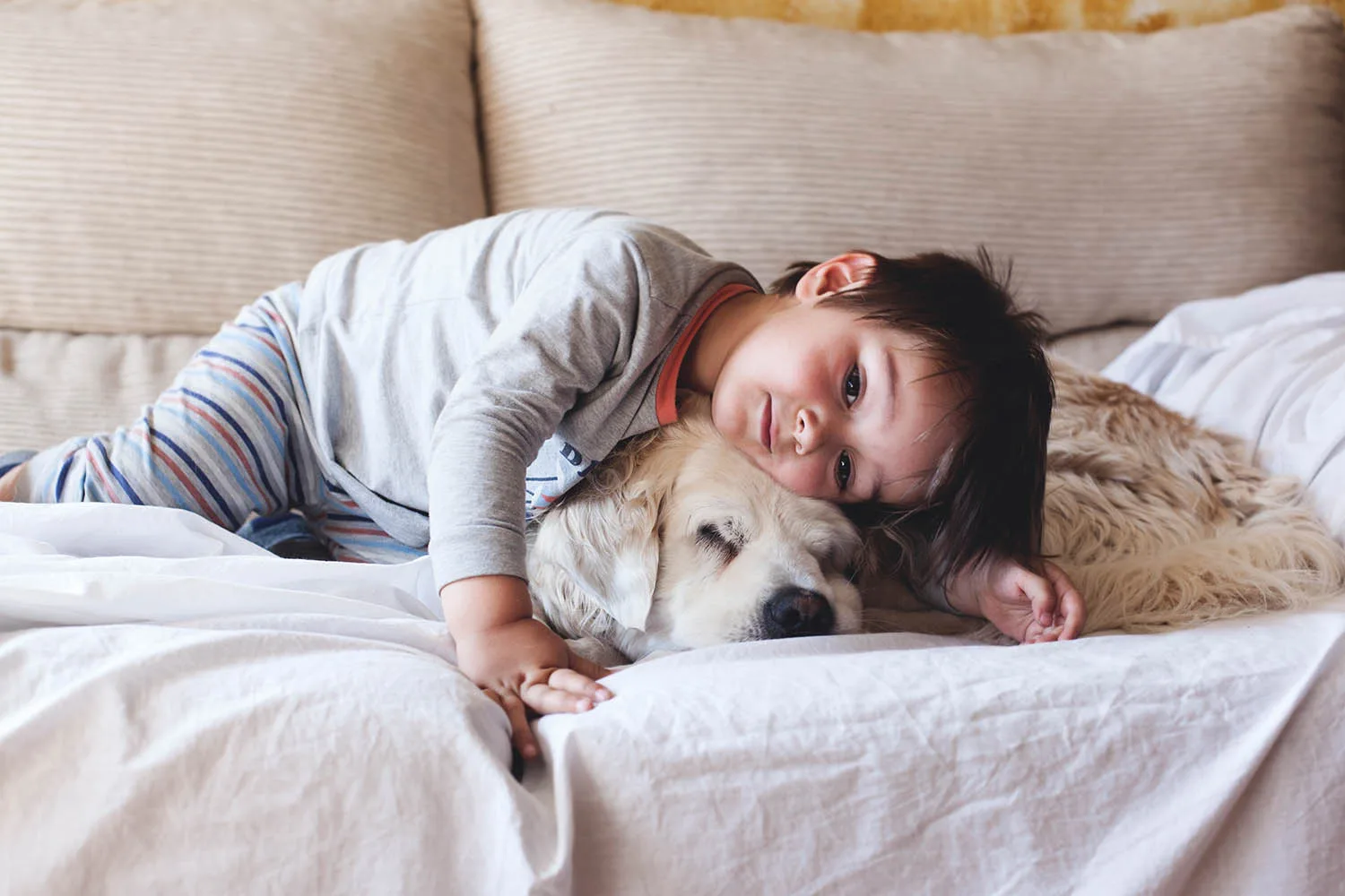 boy cuddling dog