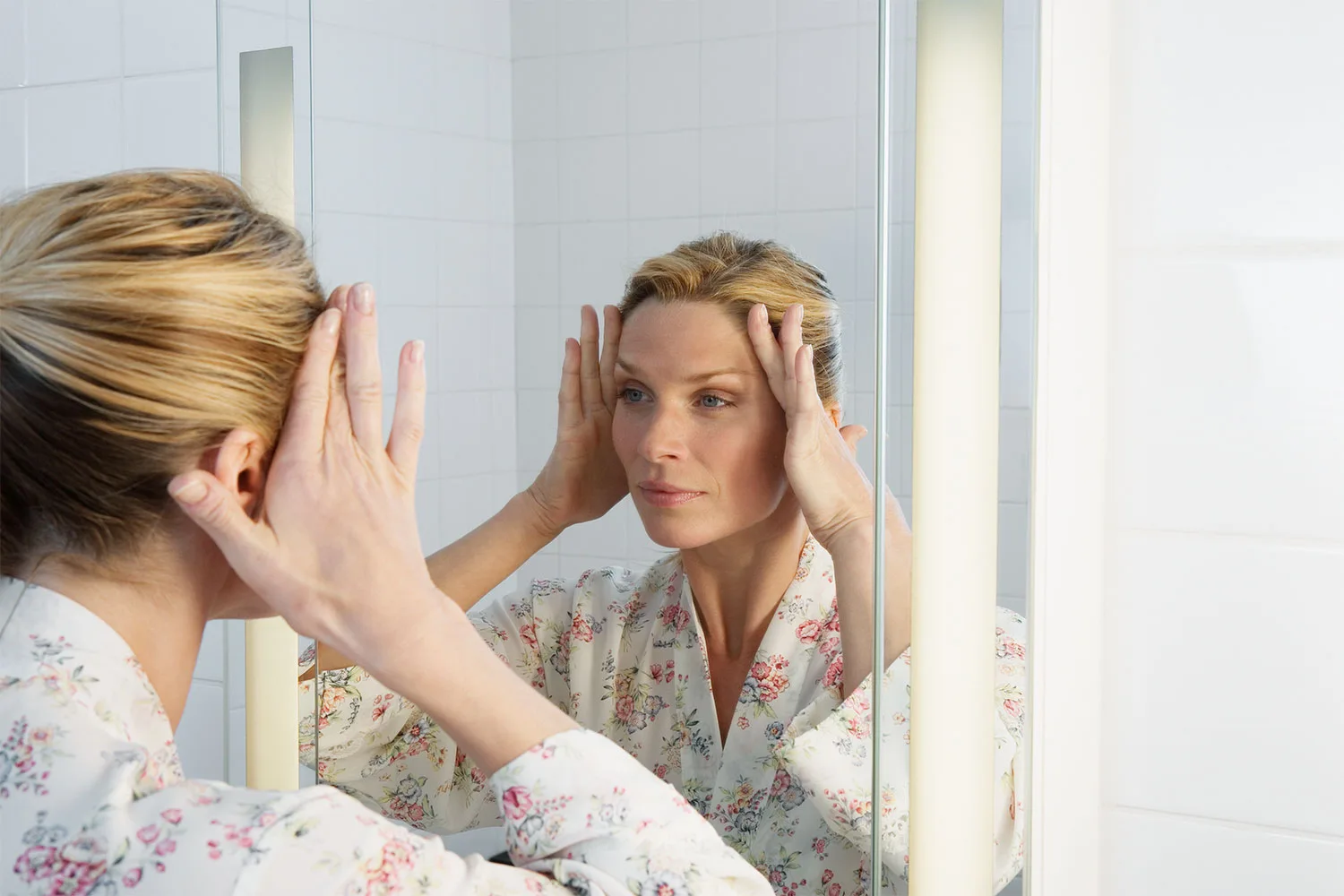 Woman looking at herself in the mirror