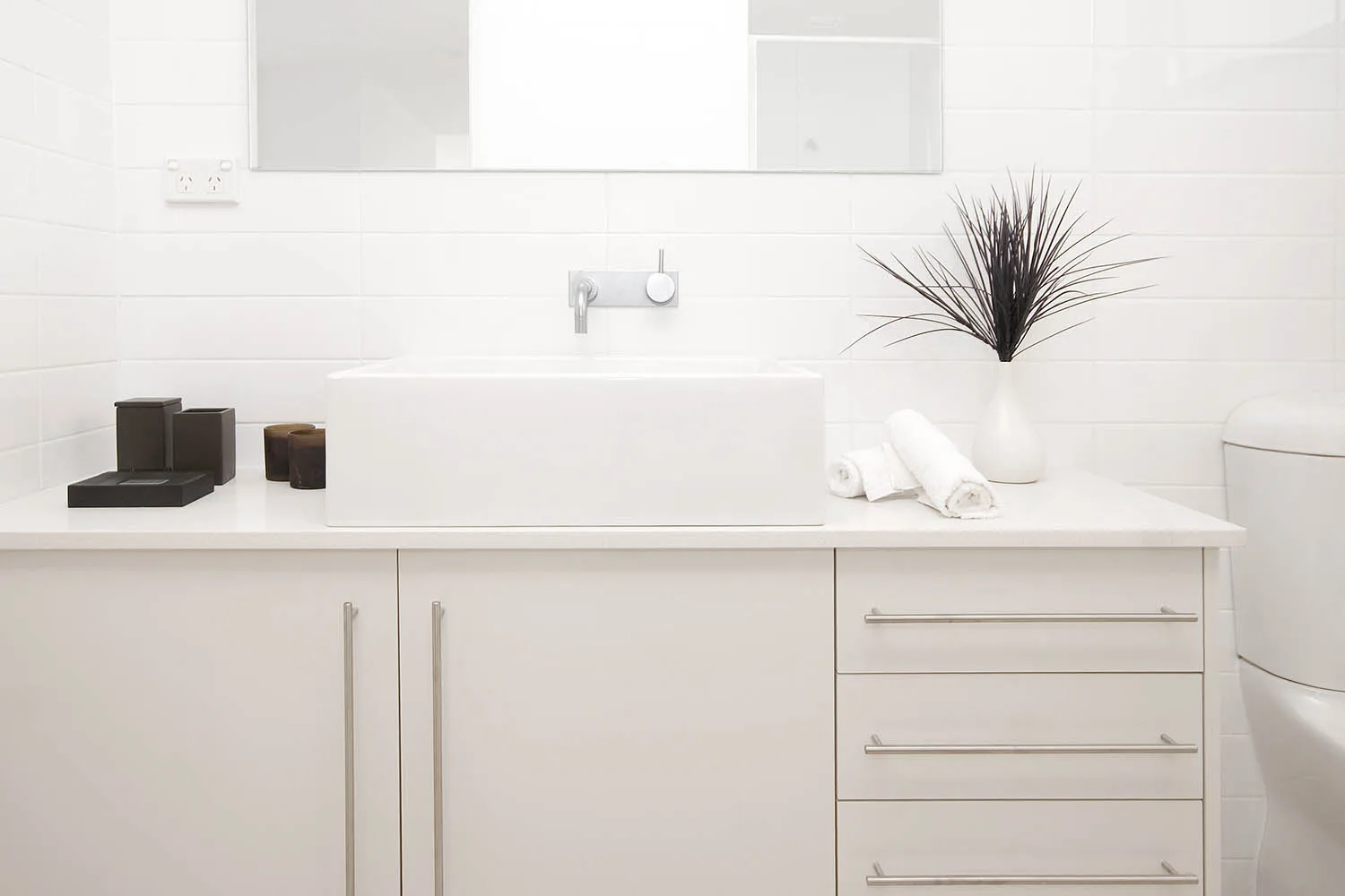 all white bathroom vanity and cabinetry