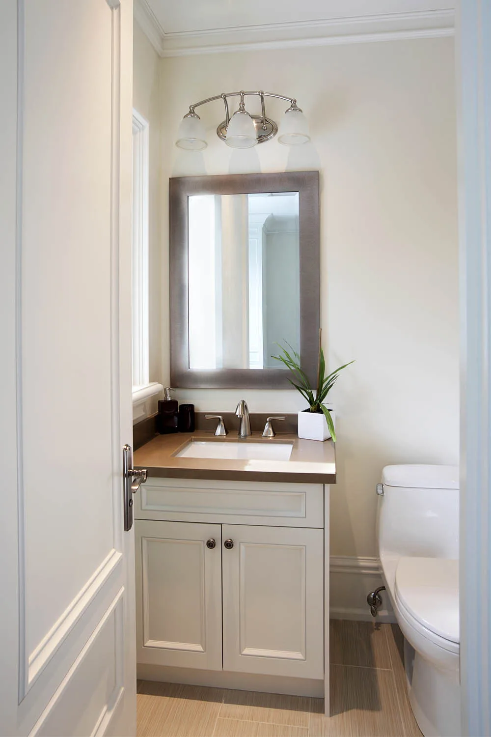 small bathroom with basic vanity and mirror