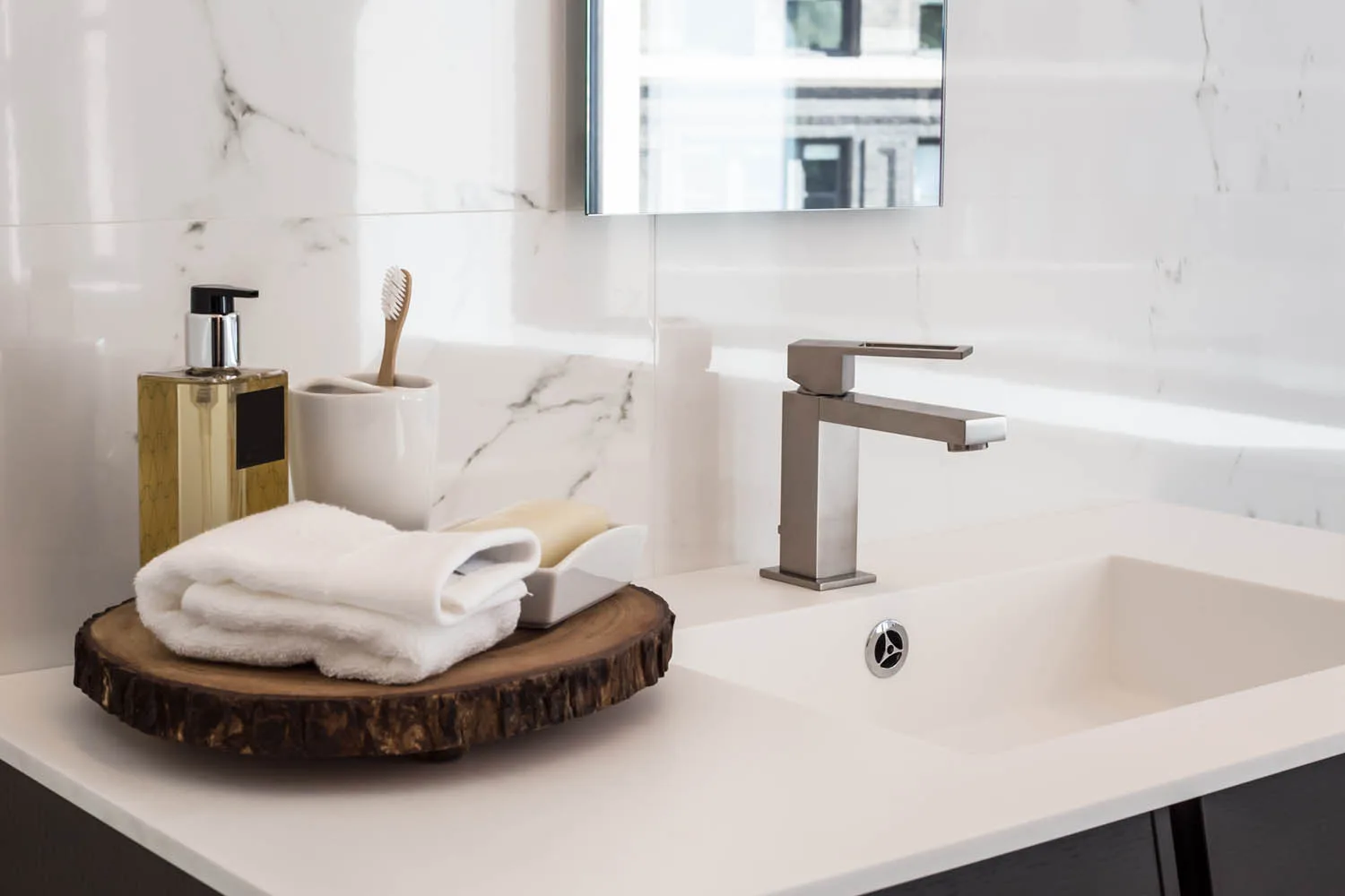 bathroom vanity detail shot with timber tray and towel