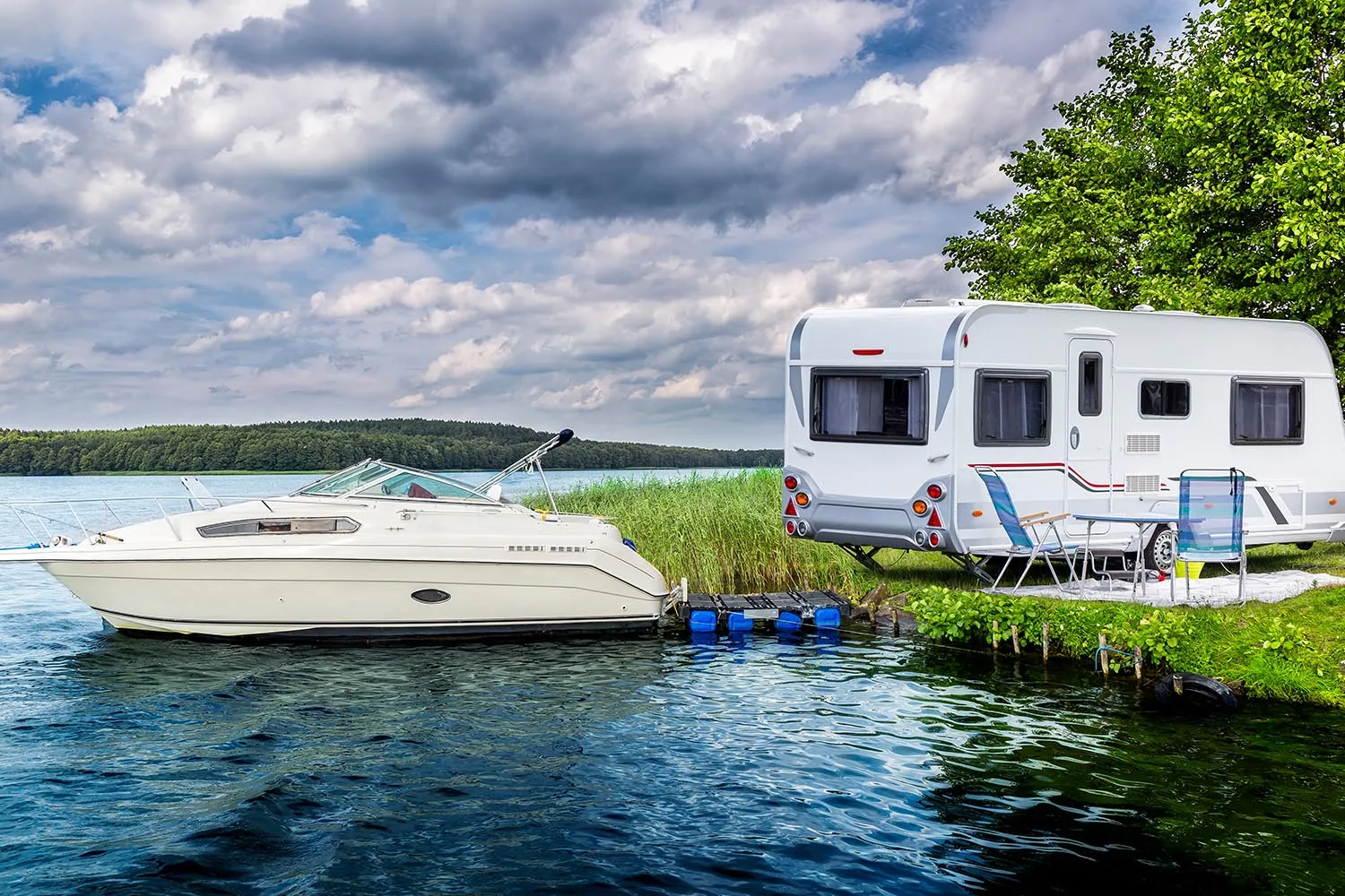 boat and caravan parked on waters edge