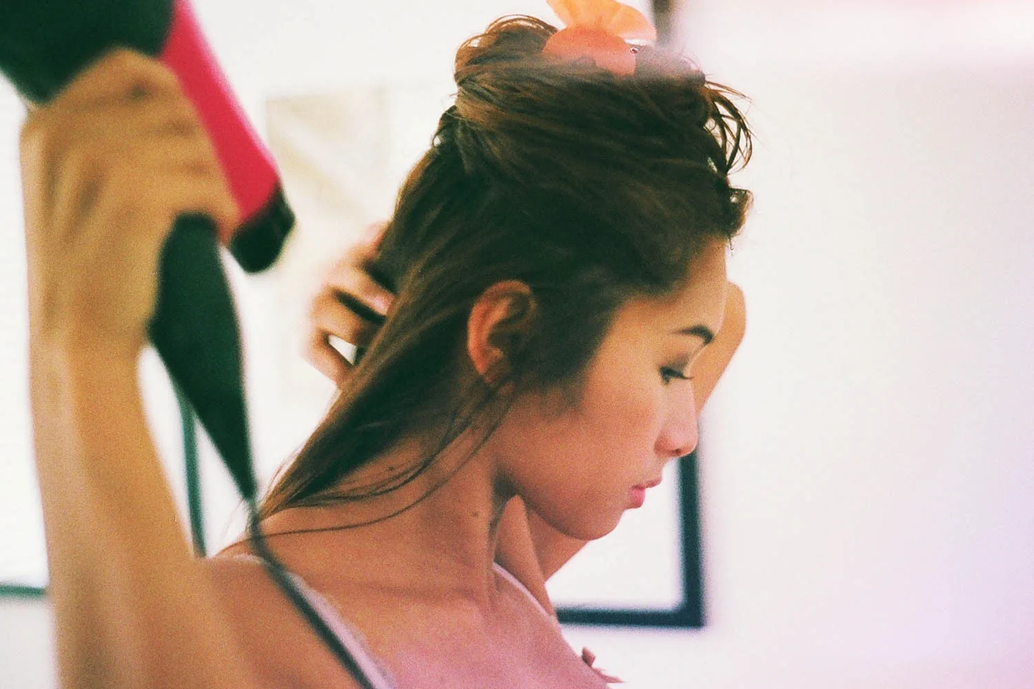 woman blow drying her hair