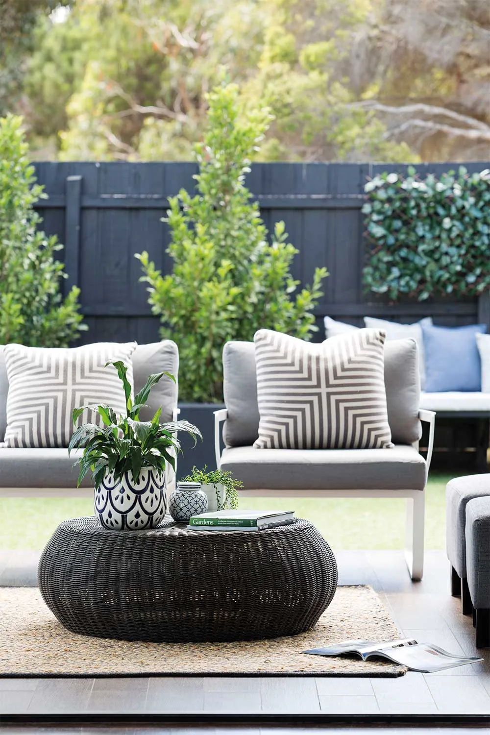 Outdoor lounge setting with round wicker coffee table