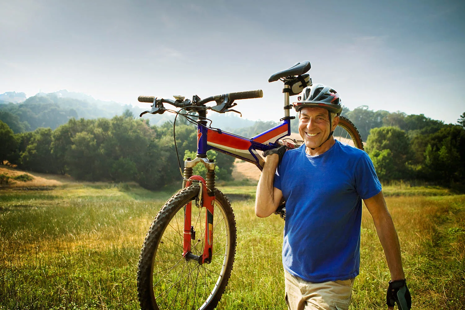 man holding bicycle walking