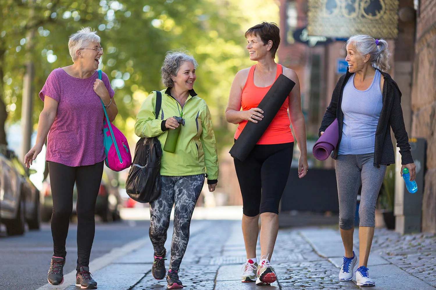four women walking to yoga