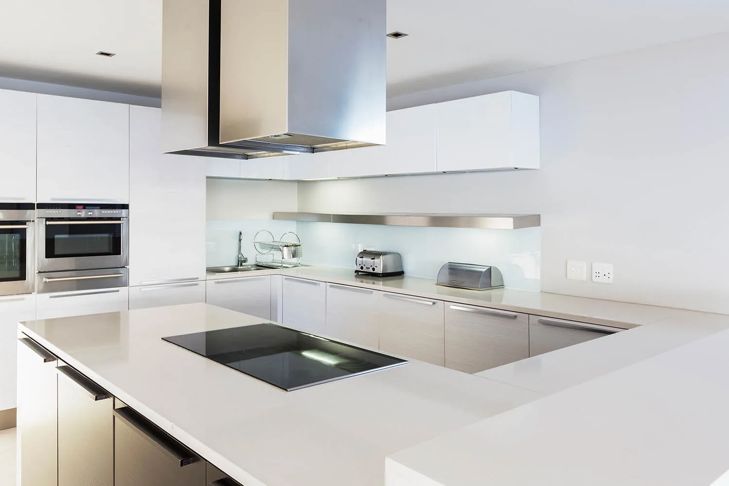 white and stainless steel u shaped kitchen