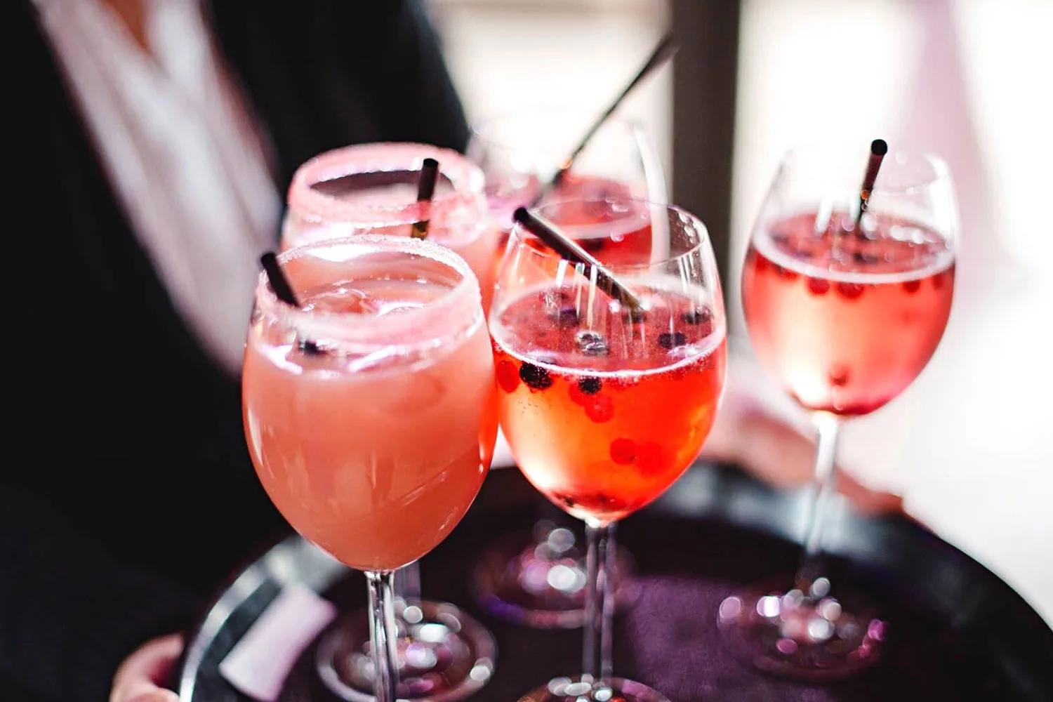 Tray of pink coloured cocktails