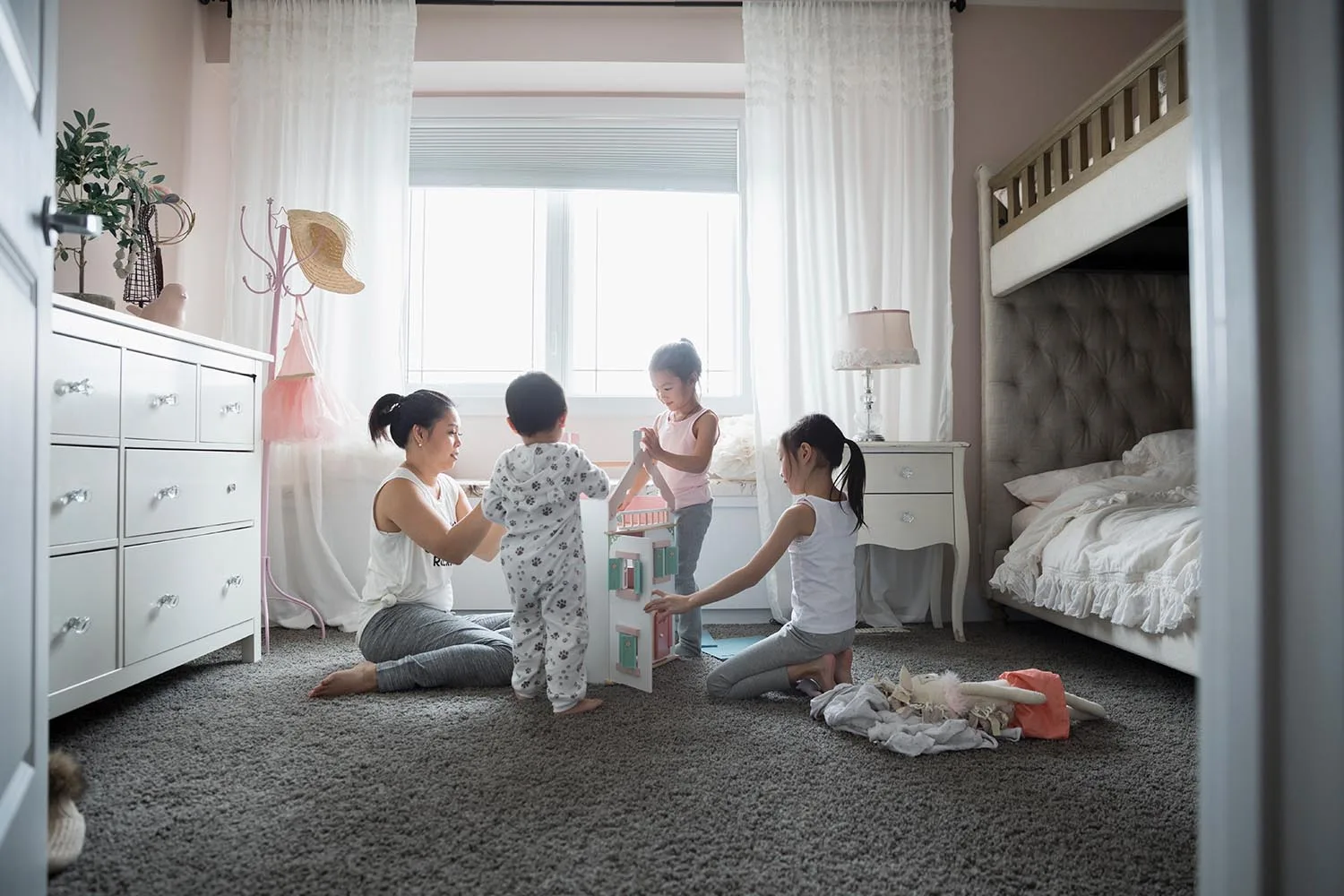 room with carpet flooring and mother with three daughters