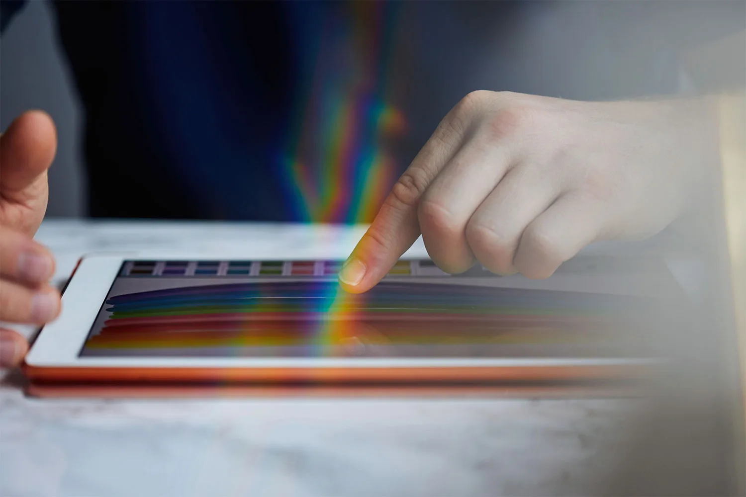 Hands touching ipad