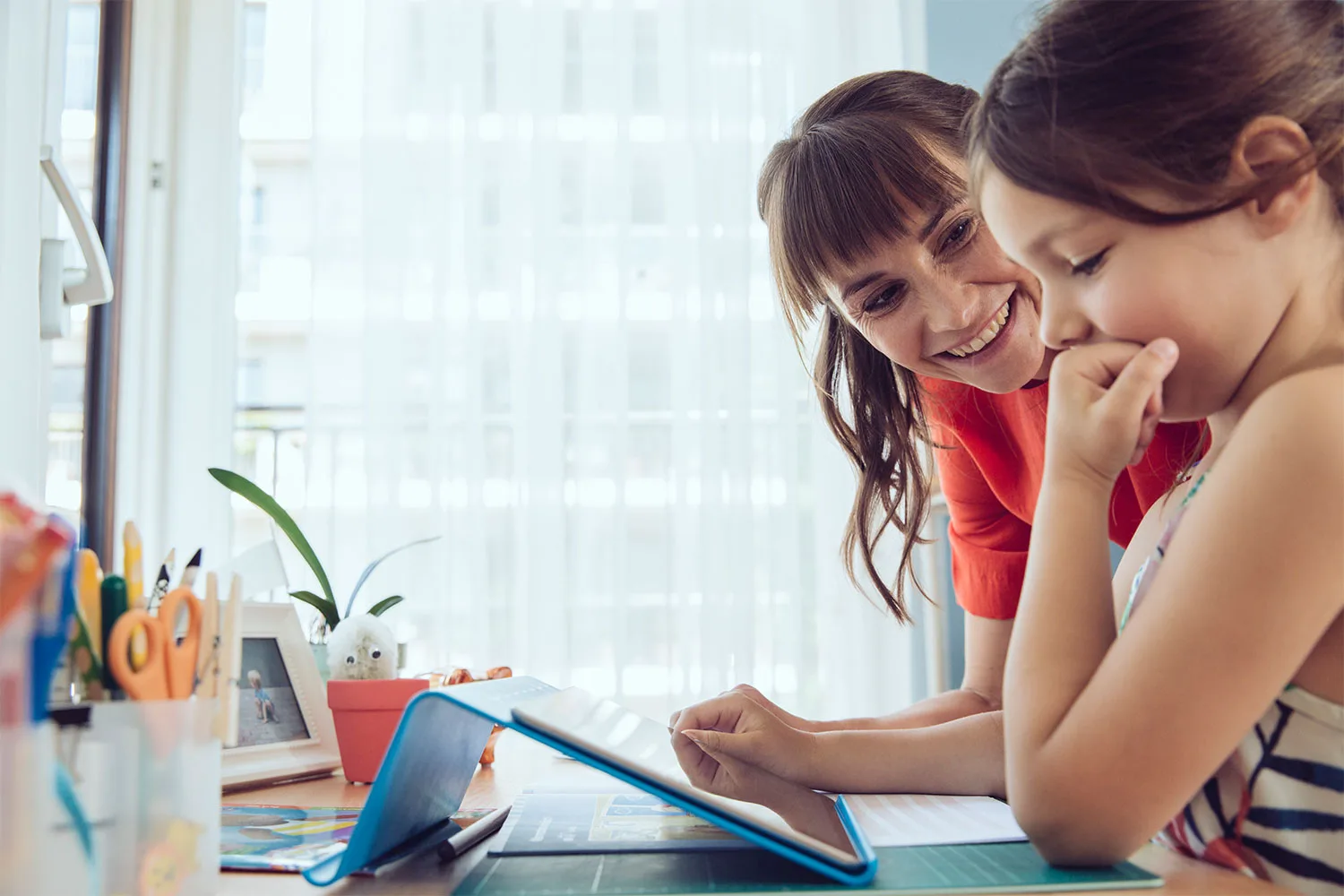 Mother and daughter using device together
