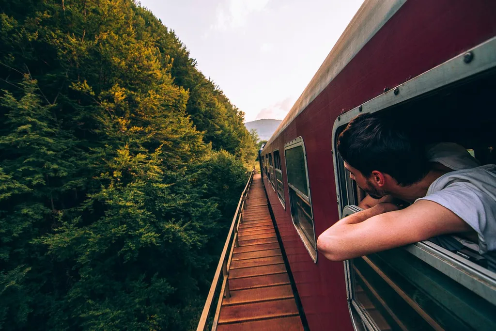 man hanging out of train window