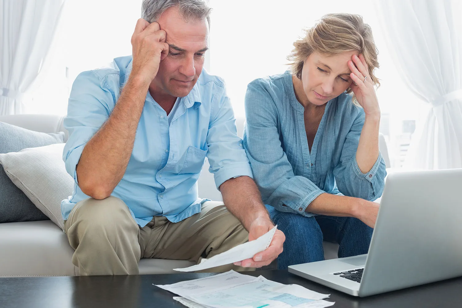 couple looking stressed at computer