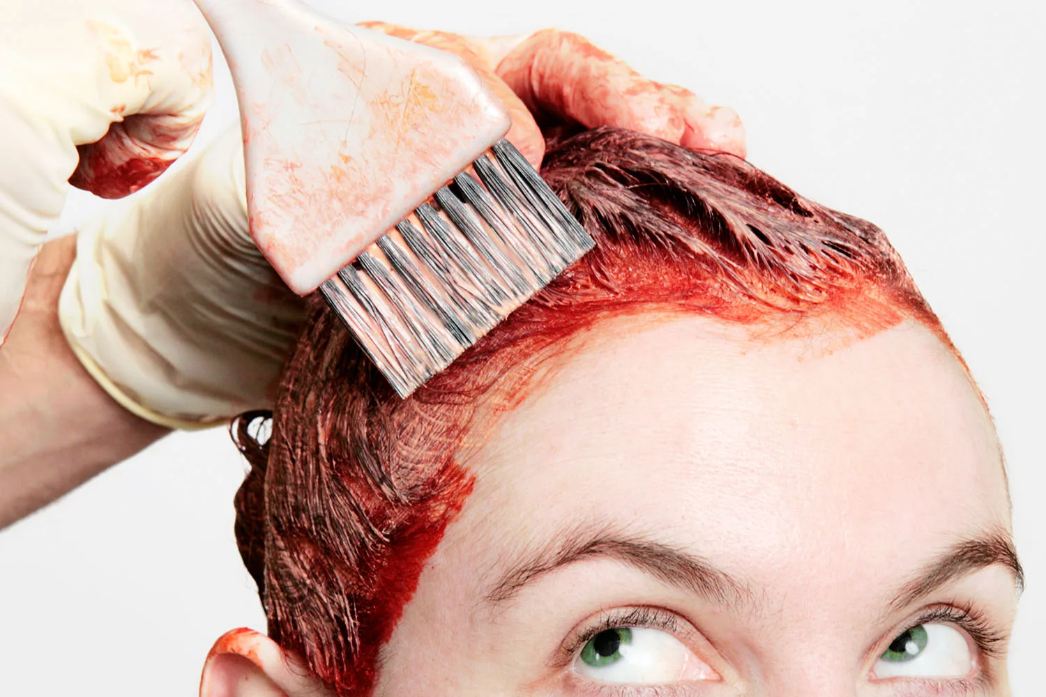 girl getting hair dyed red