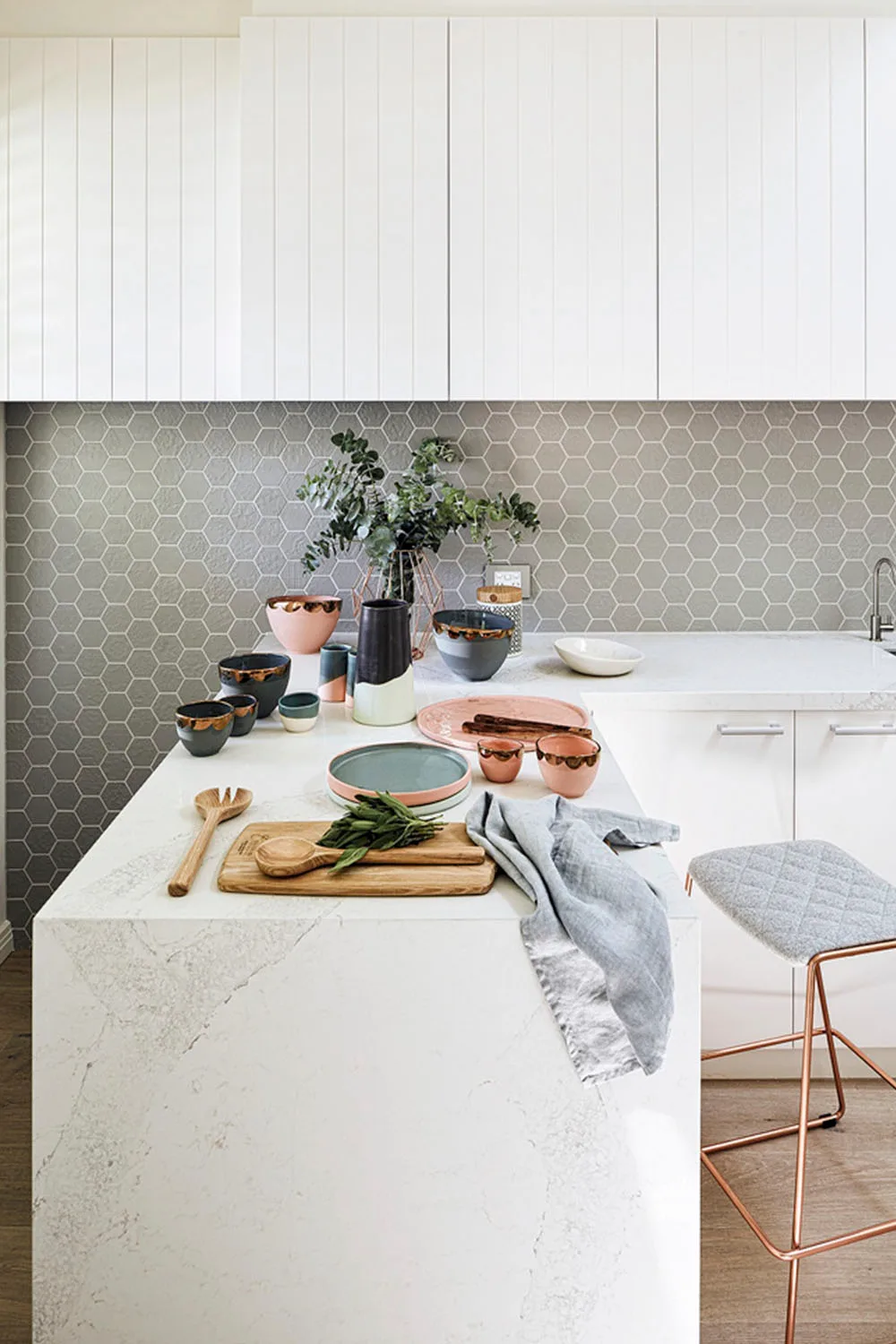 white kitchen with coloured dinnerware on bench