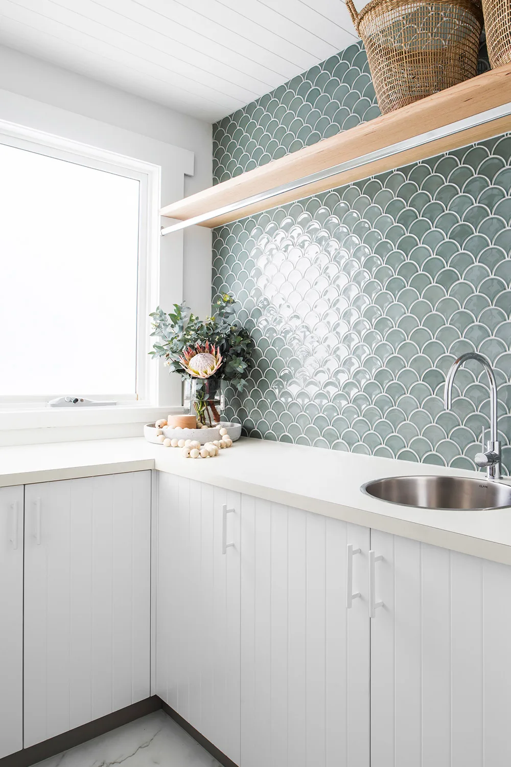 white kitchen with green tiles