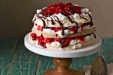 Triple layer pavlova with cherry berry sauce