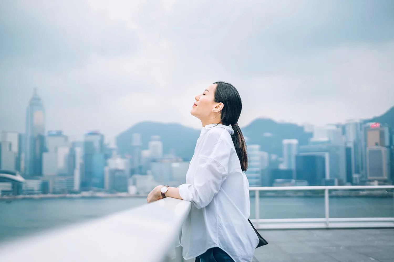 woman breathing standing on rooftop