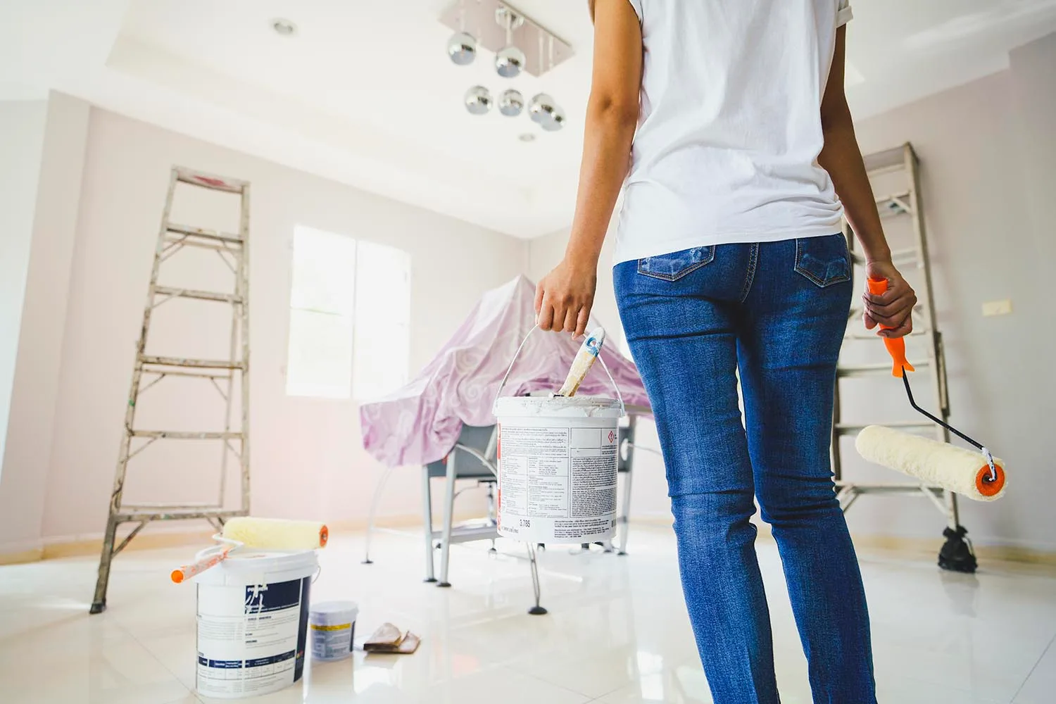 woman carrying tin of paint